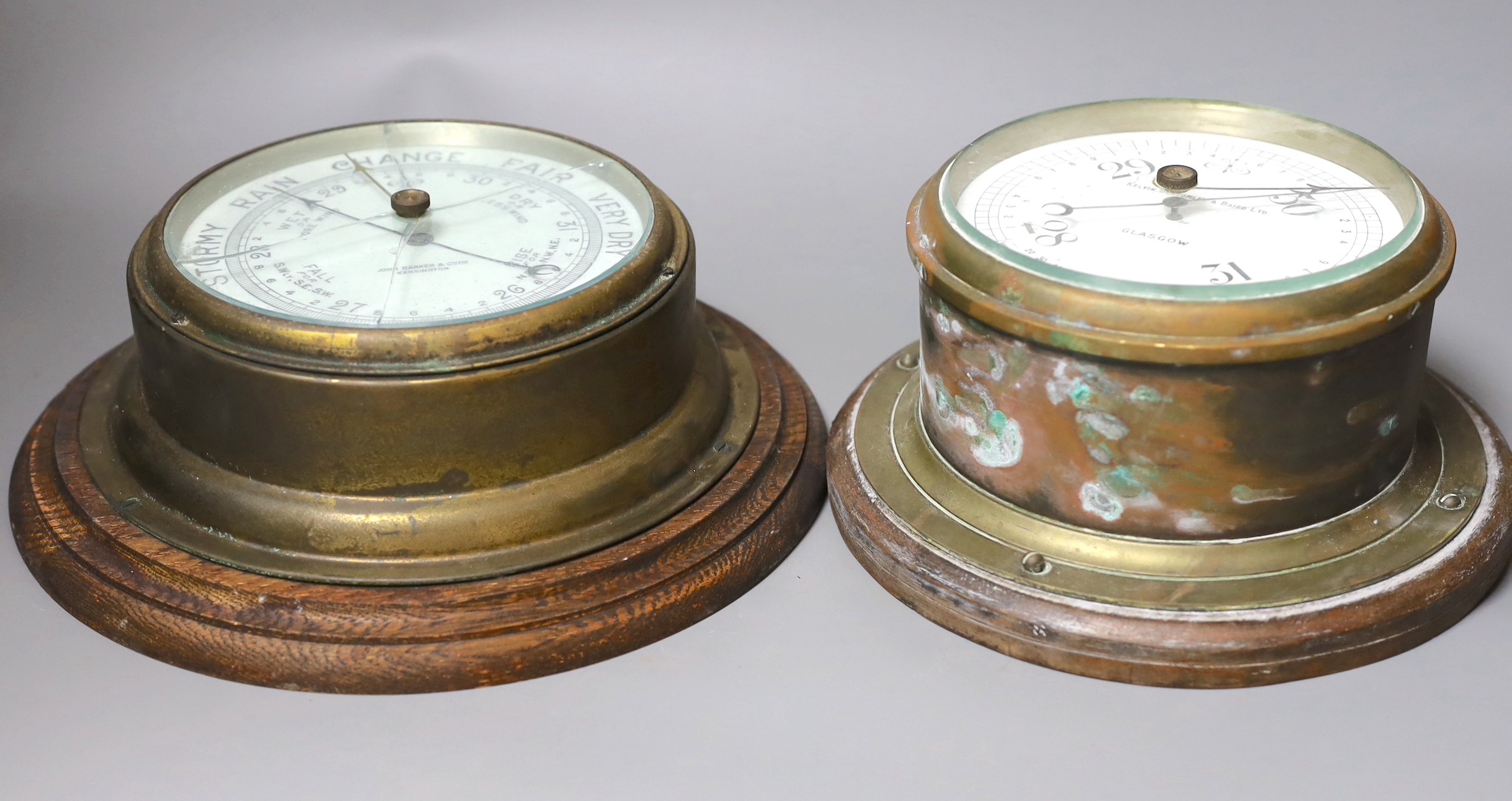 A John Barker & co brass bulkhead barometer and another by Kelvin Bottomly & Baird ltd., diameter 27.5 cm
